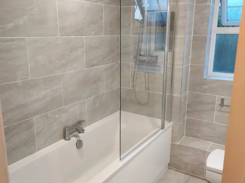 Refreshed shower space with brand new walk in shower fitted over bath and full wall tiling.